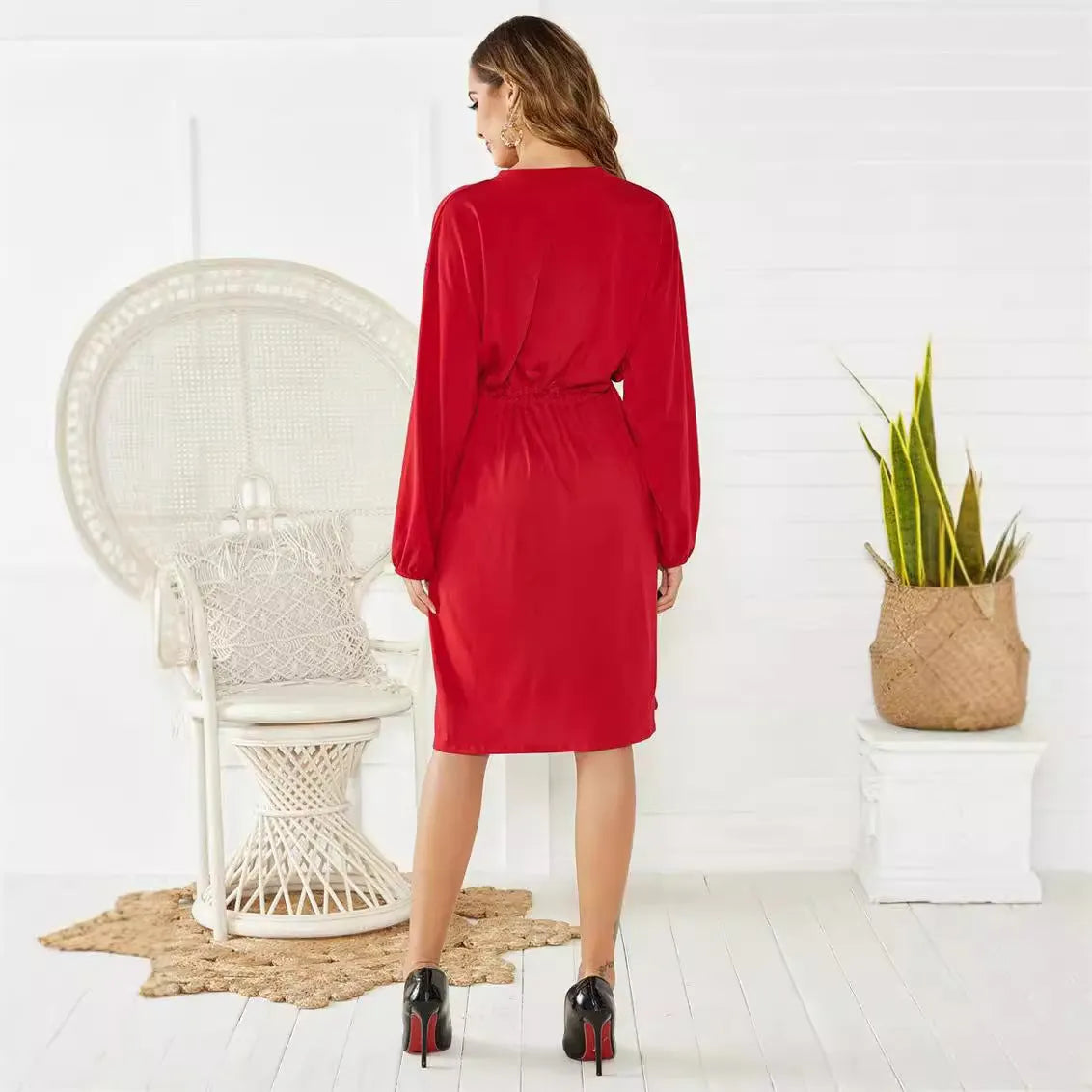 Black solid colour A-line midi dress with an elastic waist, long sleeves, and an attached belt.
