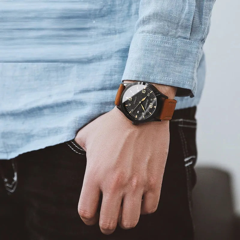 Men's automatic mechanical watch with leather strap on wrist, showing business casual retro style.