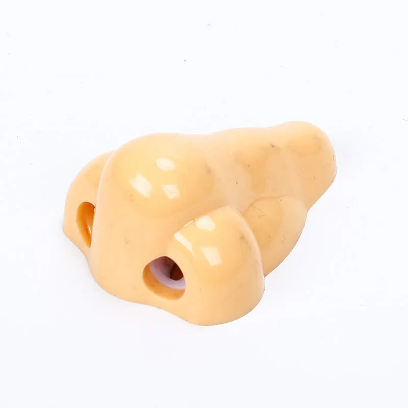 Flesh colour plastic big nostril manual pencil sharpener with geometric shape.