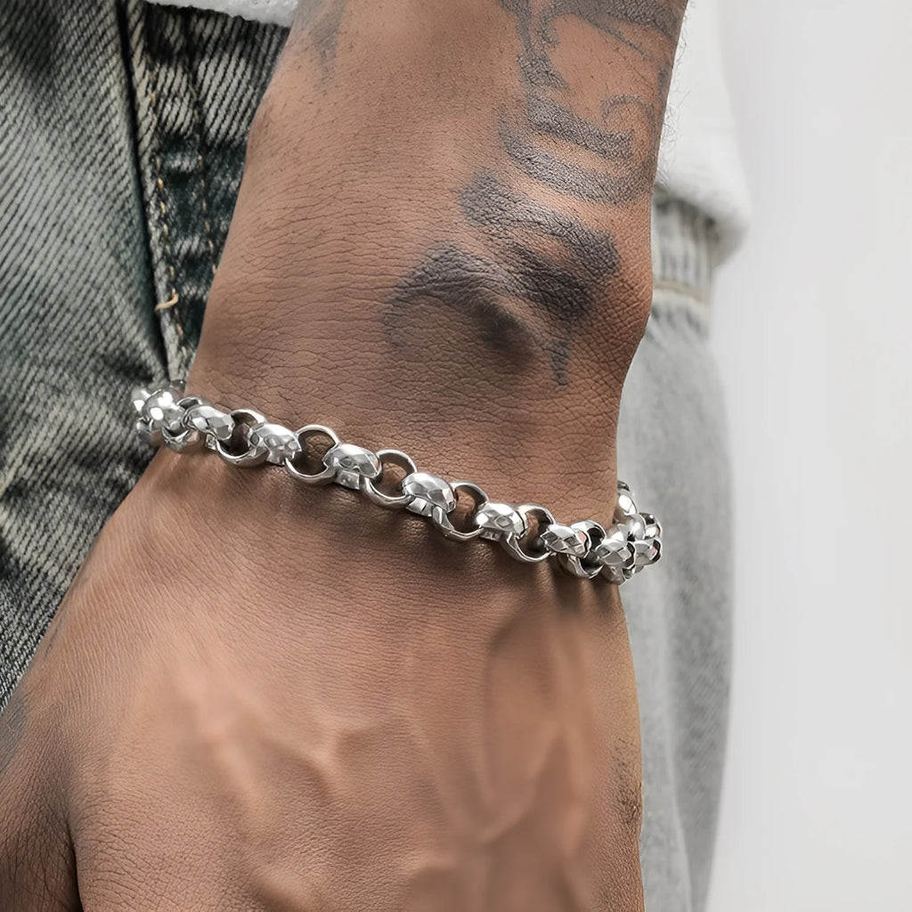 Silver titanium steel bracelet with diamond pattern and O-ring closure on a white background