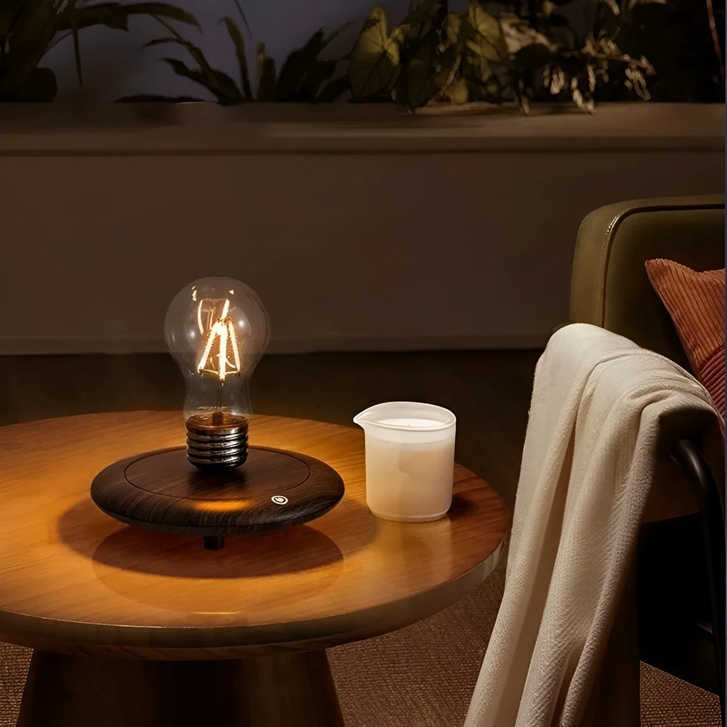 Black iron art suspension bulb decorative night lamp on a wooden desktop.