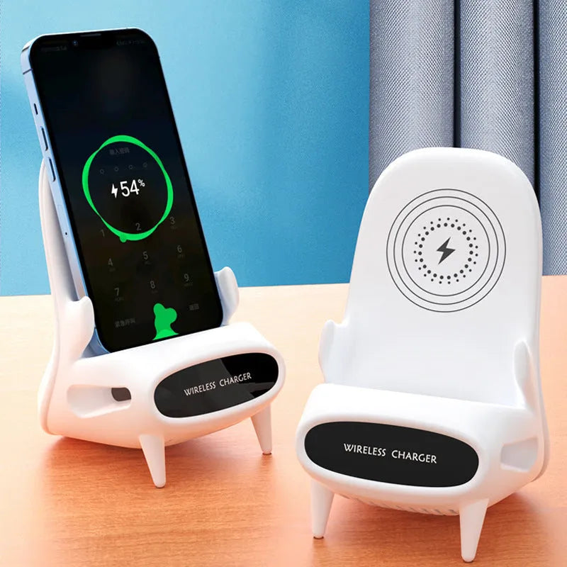 White mini chair shaped wireless charging stand holding a mobile phone on a desk.