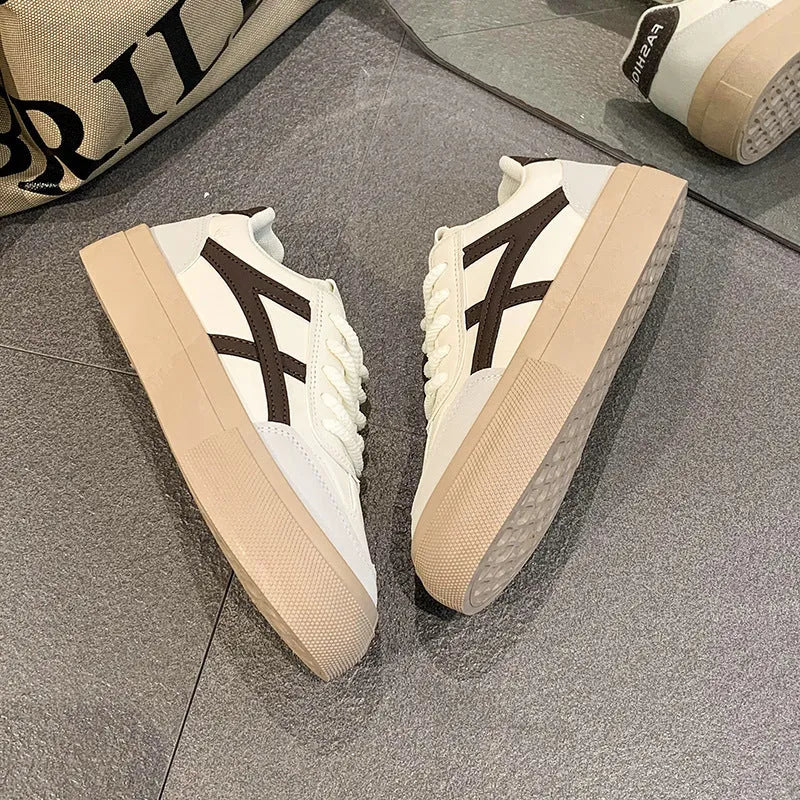 Brown and blue low-top casual lace-up shoes with a round toe and flat rubber sole.
