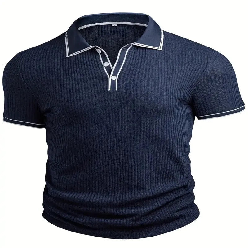 Man wearing a loose-fit striped polo shirt in a summer setting, showing short sleeves and collar detail.