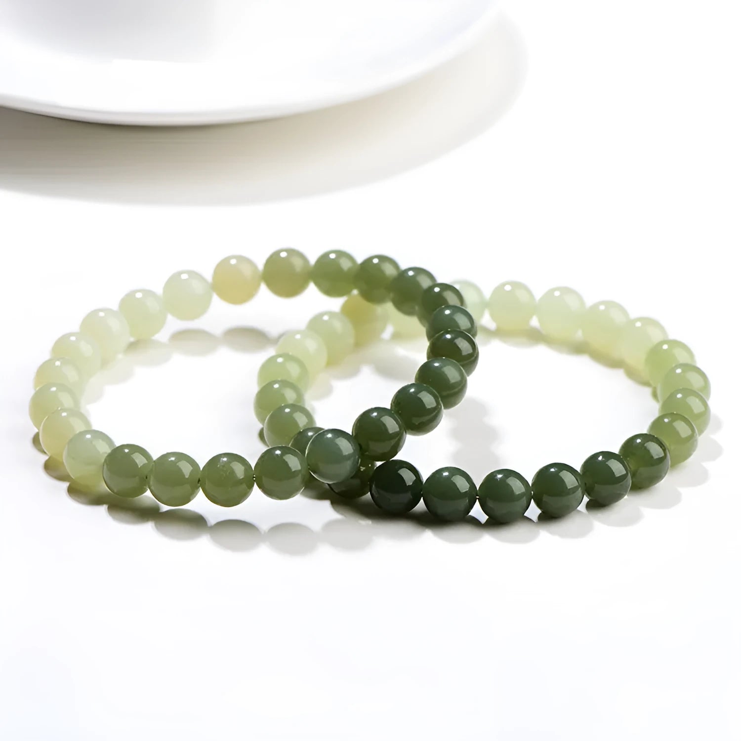 Natural clear water Hetian jade bracelet with round beads and barrel bead options on a wrist.