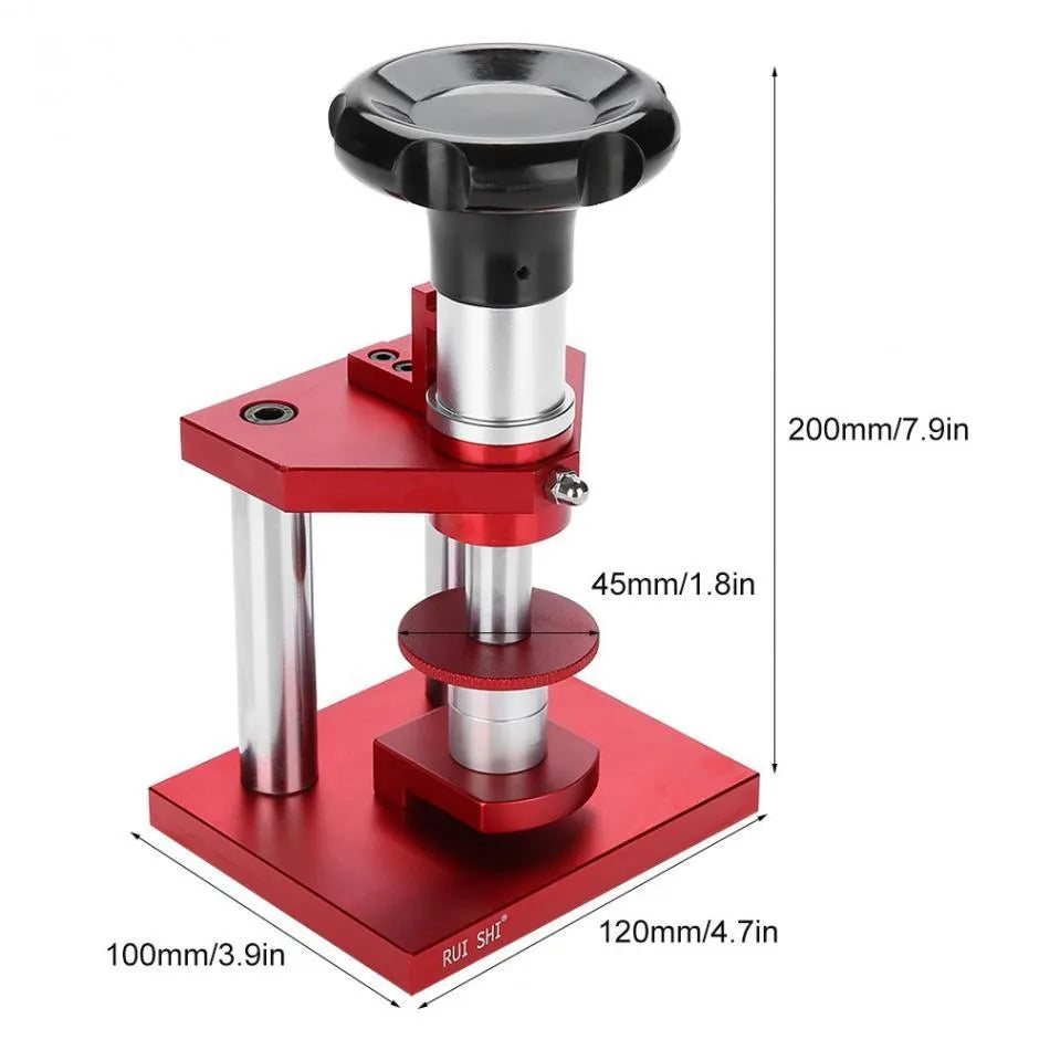 Watch repair spiral cap presser device with capsulator and set of 20 plastic moulds on a work surface.