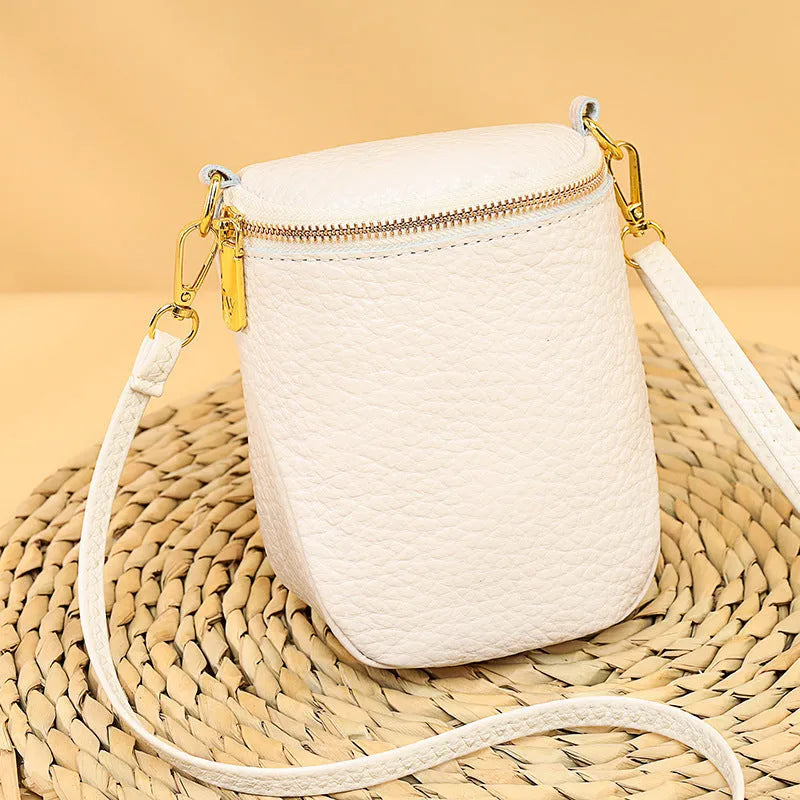 Genuine leather small crossbody bag in black with adjustable strap and shell shape design