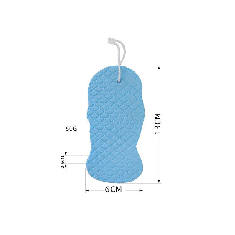 White 3D fish scale pattern bath sponge with hang loop on a bathroom background.