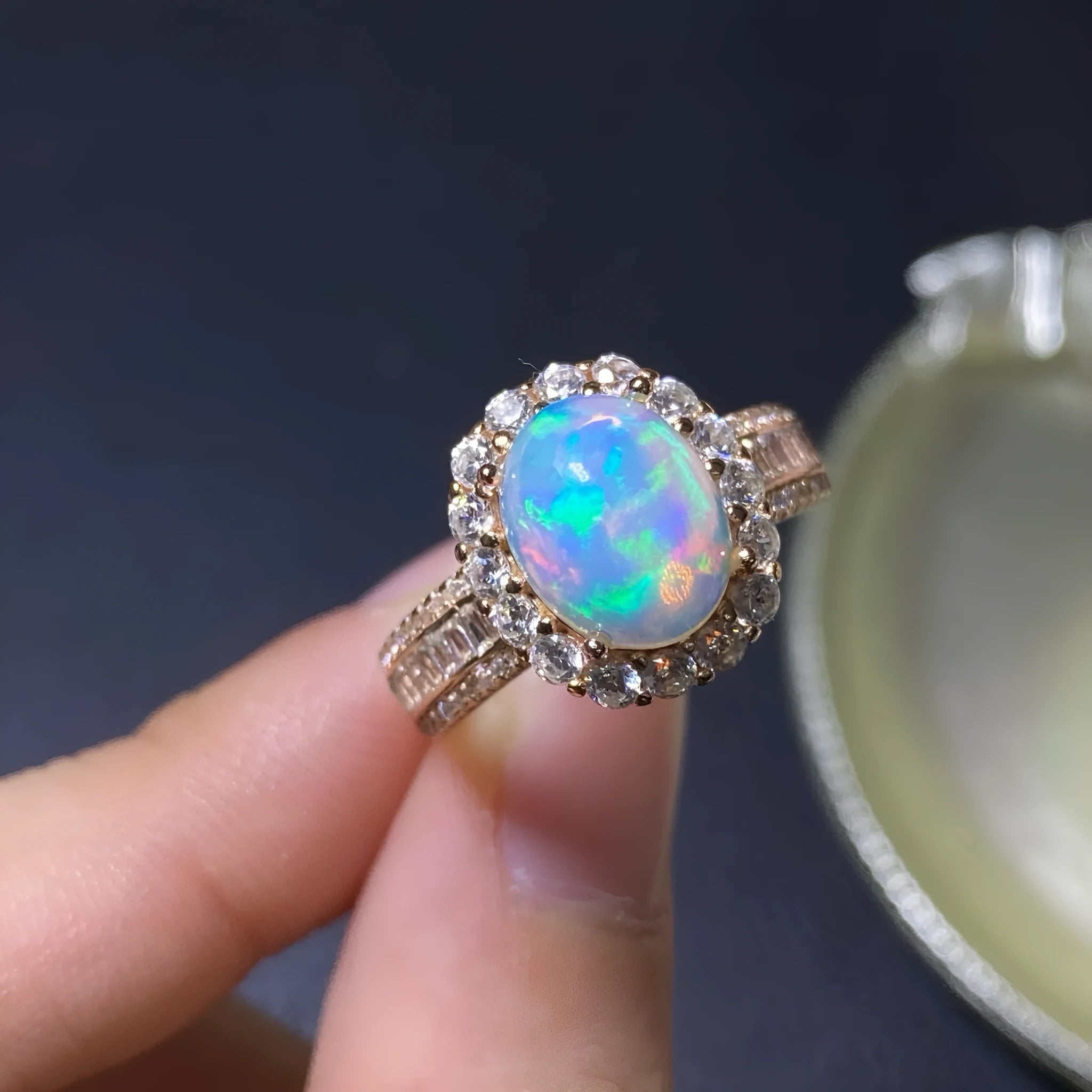 Handmade adjustable silver ring with a natural opal, shown in rose gold plating.