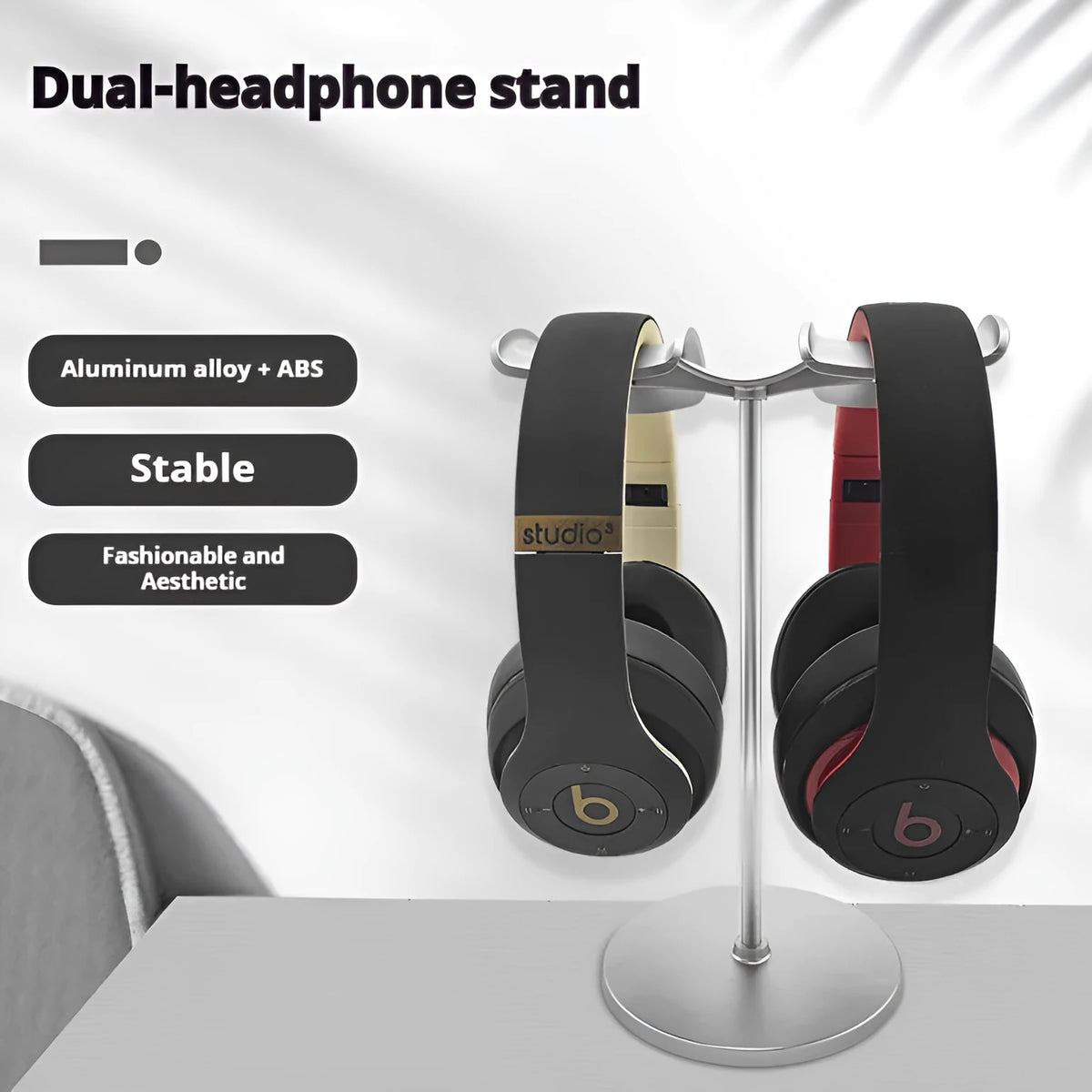 Desktop double-hanging earphone bracket in double-headed black holding two headphones on a desk