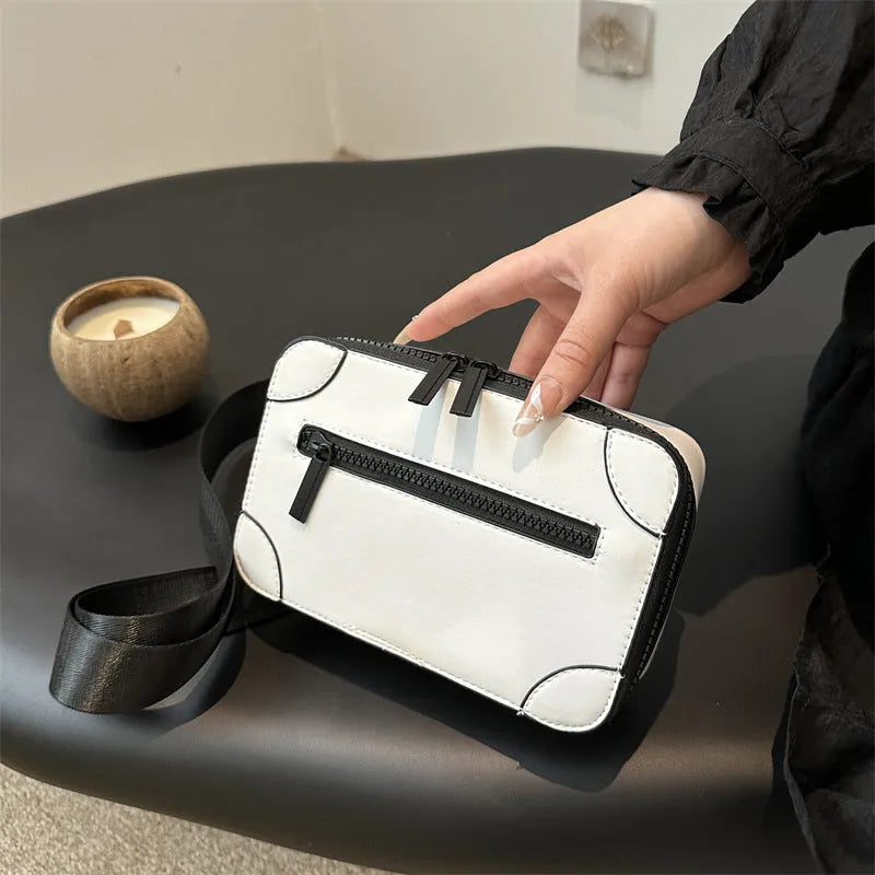 Small square black women's crossbody bag with single strap and external pockets