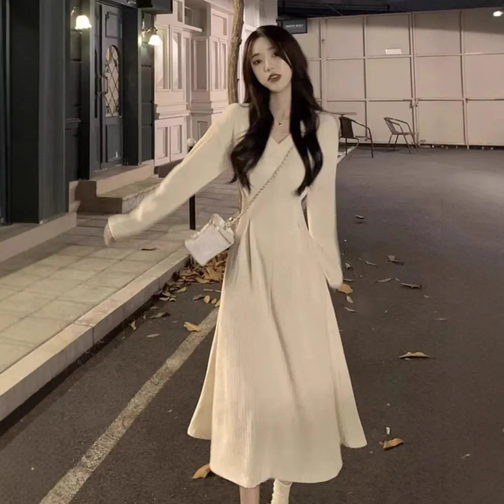 Women's V-neck knitted dress with princess sleeves in milky white colour showing long skirt length