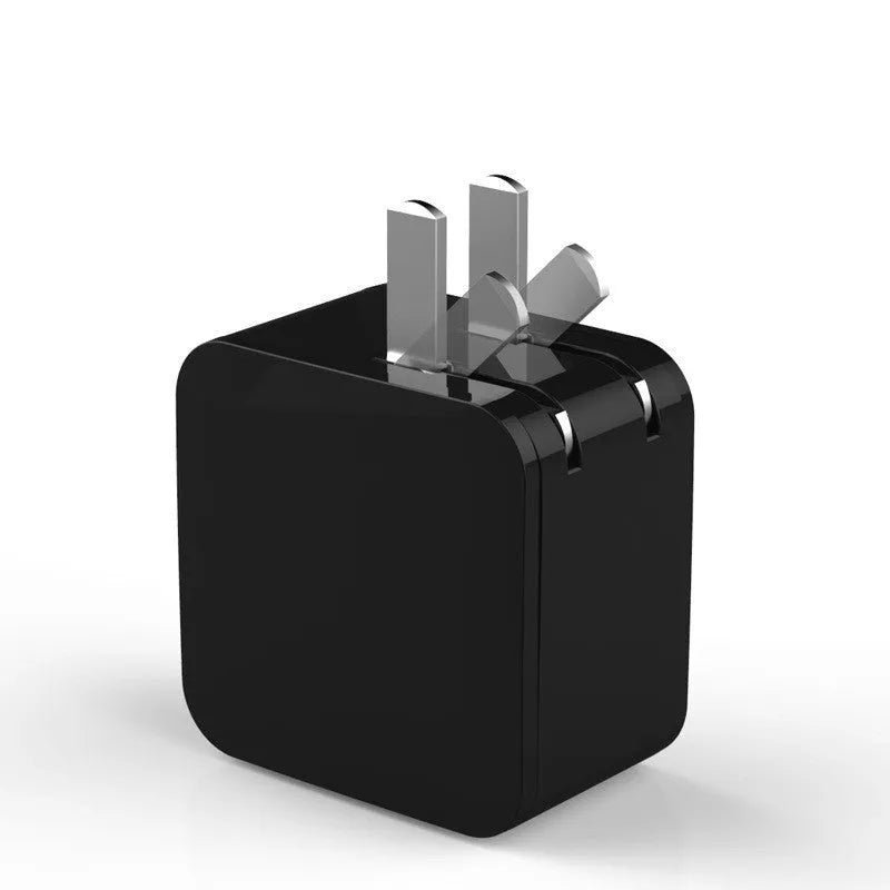 Compact black dual USB travel charger with a digital voltage display showing 5.0V, next to a UK plug.