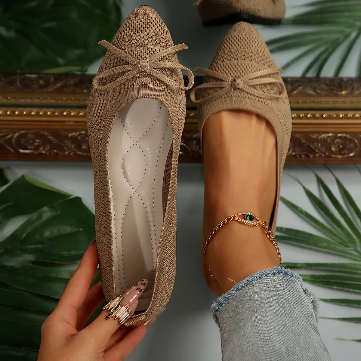 Women's blue knitted loafers with a bow detail and pointed toe on a flat rubber sole.