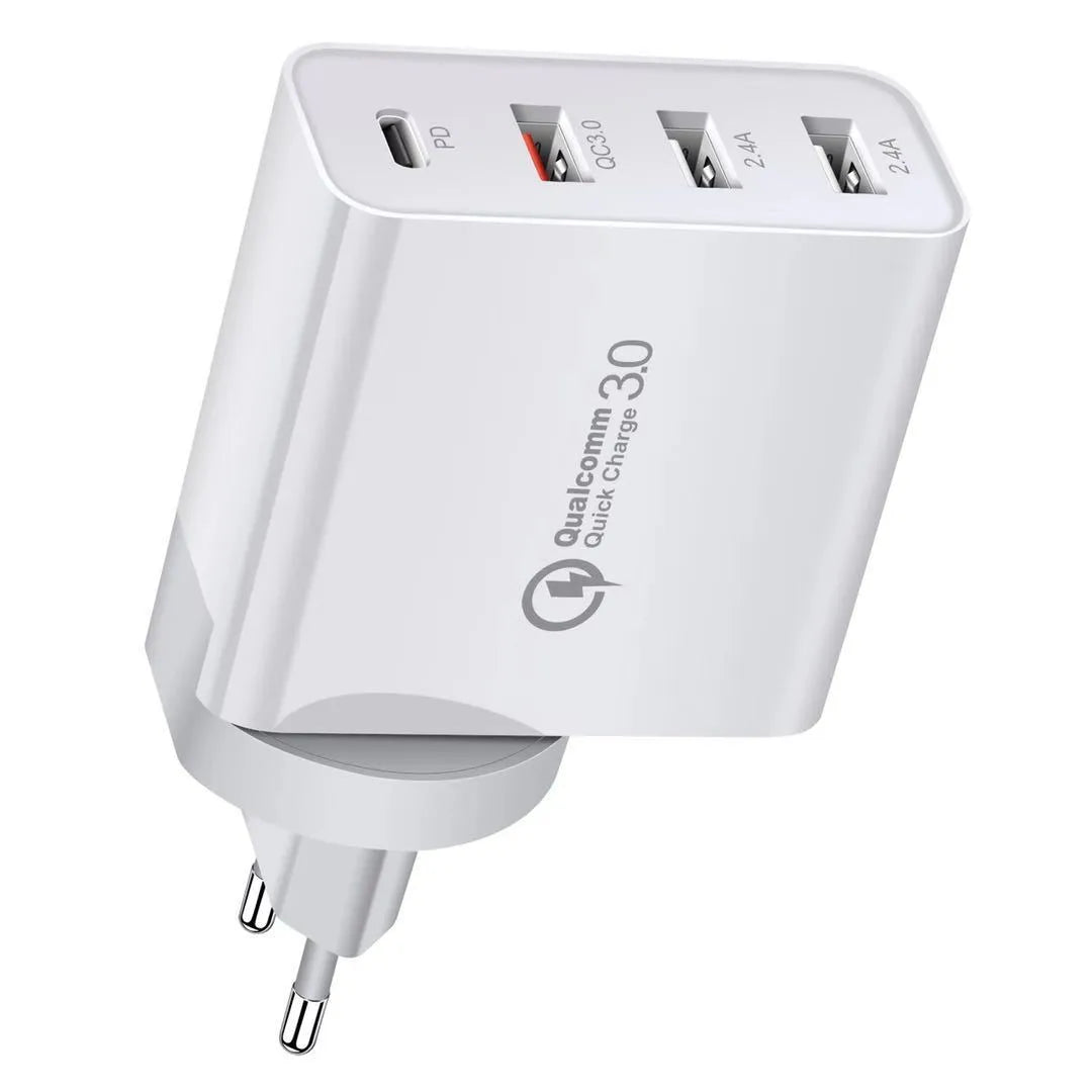 A white multi-port USB fast charger with UK plug and multiple USB-C and USB-A ports on a wooden table.