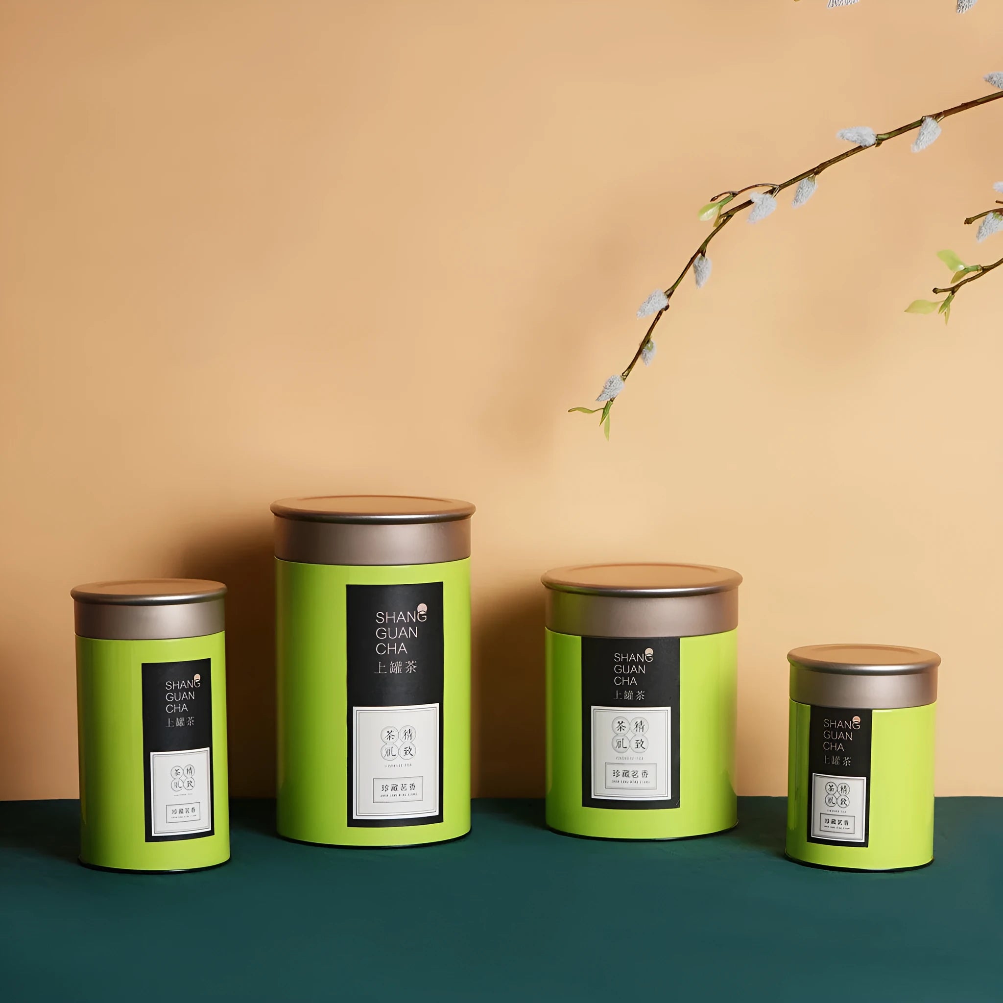 Green airtight tinplate tea storage can with sealed lid, 155mm tall.