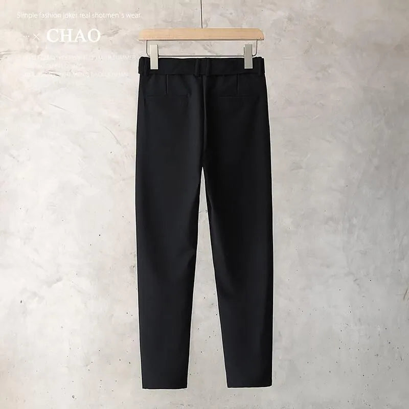 Boys slim straight wool trousers in tapered fit, shown in black, on a hanger.