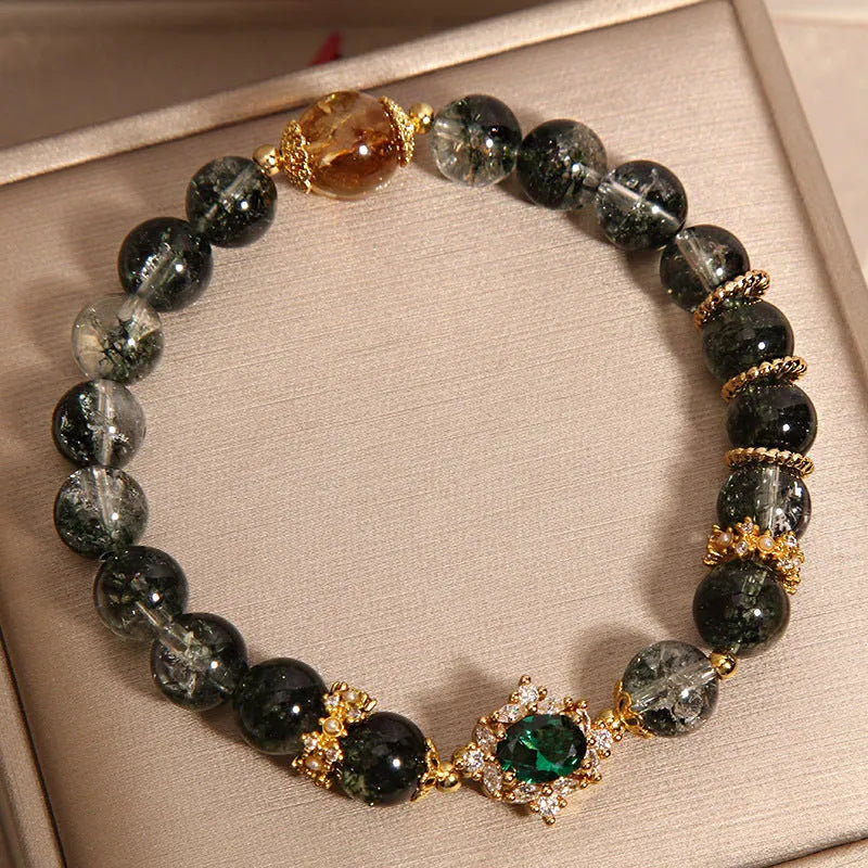 Gold rutilated quartz crystal bracelet with green phantom quartz and visible rutile inclusions