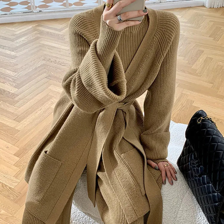 Women's apricot knitted cardigan, top, and wide-leg trousers set with black leather stitch trim detail.