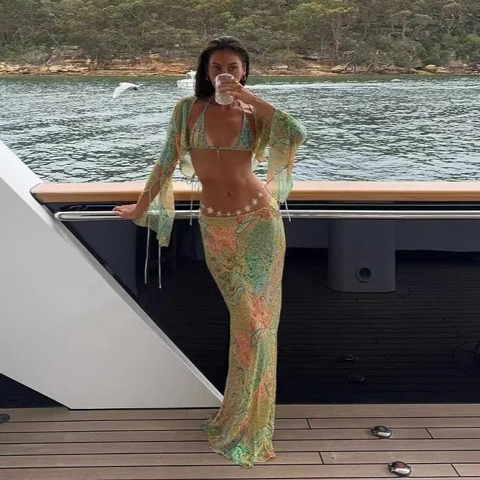 Green halterneck printed lace-up split swimsuit with long bell sleeves on a model