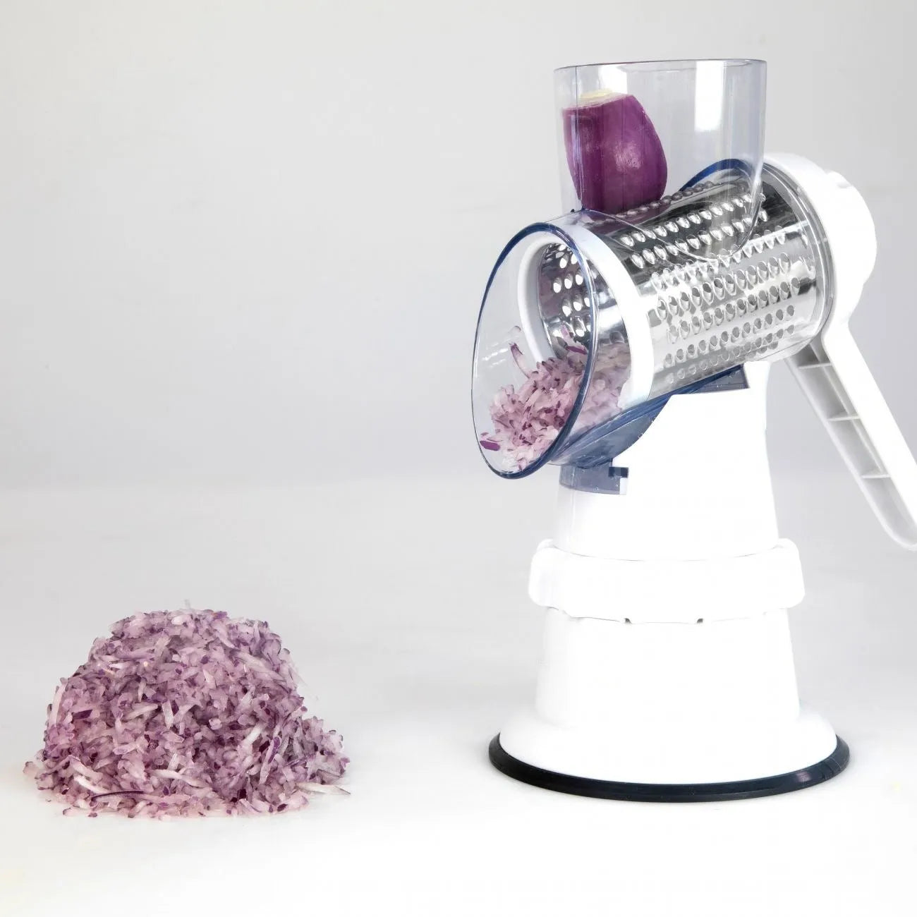 White 3-in-1 manual vegetable slicer with stainless steel blades on kitchen counter