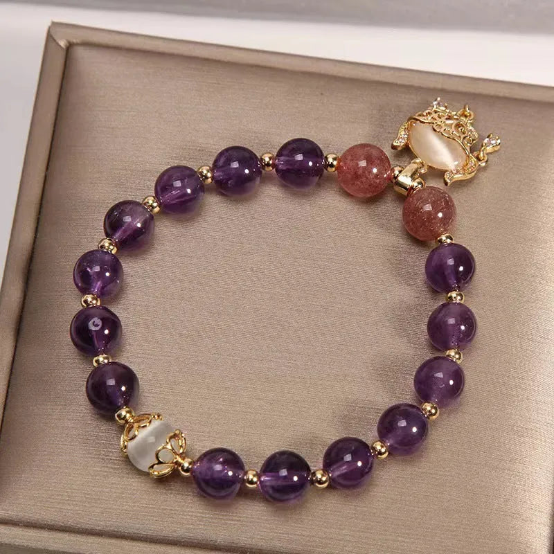 Handmade copper women's bracelet with a drop-shaped longevity lock charm and natural amethyst stones.