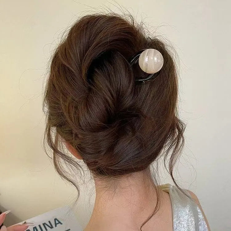 Acrylic U-shaped hair barrette with a retro ball design in a simple style.