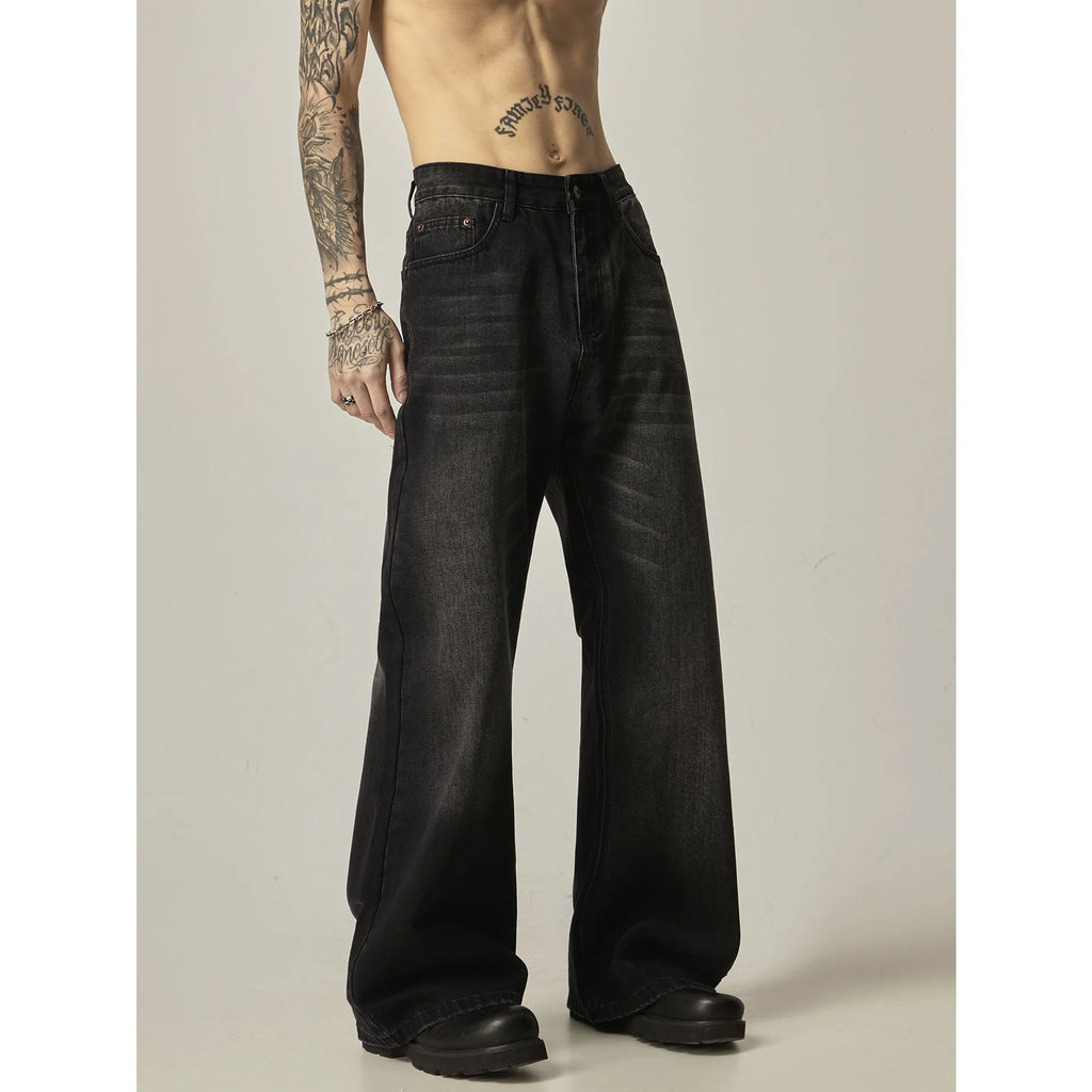 Black straight-leg jeans with retro styling and loose fit on man