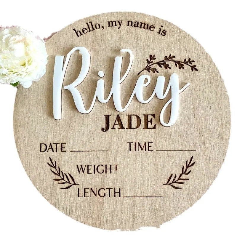 Square wooden newborn name label plaque for baby birth information on a natural plywood background.