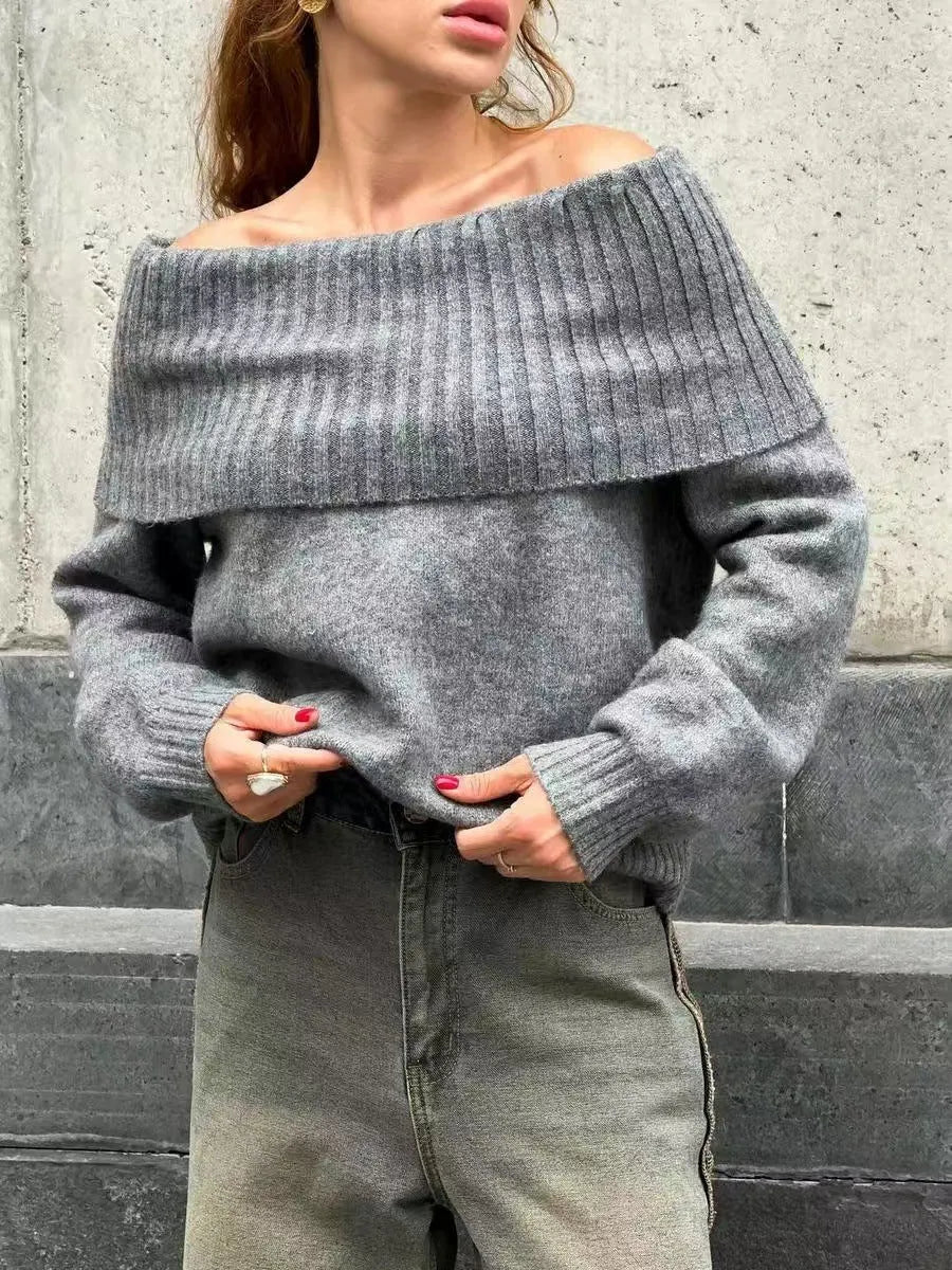 Grey off-the-shoulder sweater with a 3D pattern texture on the fabric.
