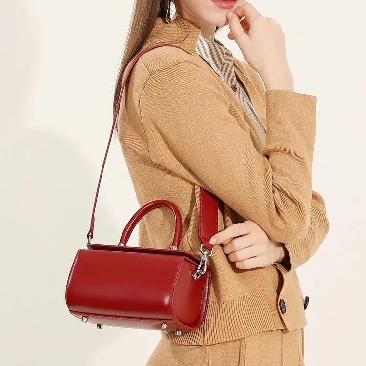 Women's leather crossbody bag in clamshell design with internal phone and document organisers