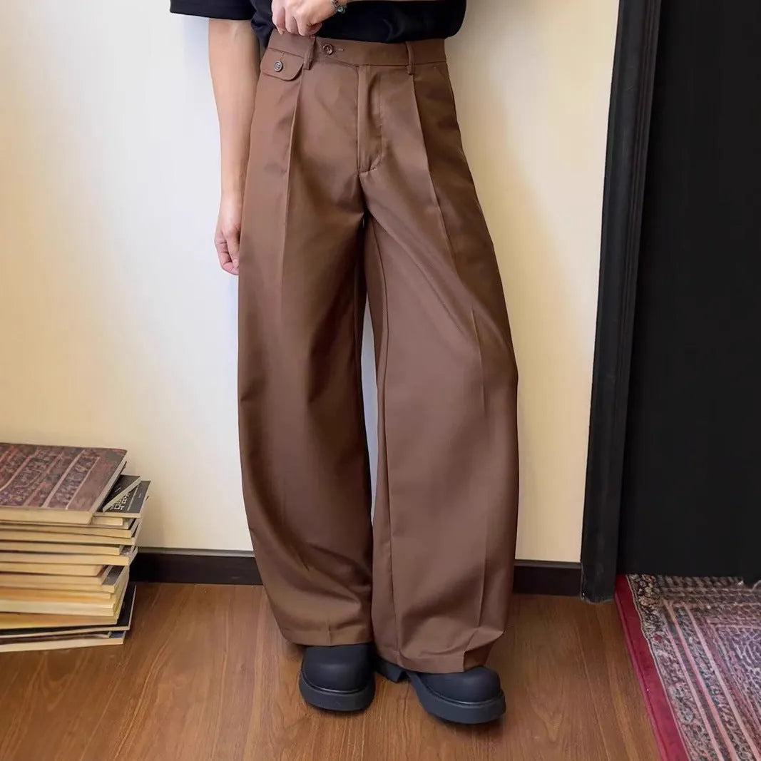 Man wearing brown straight wide-leg casual suit trousers made from a polyester blend fabric.
