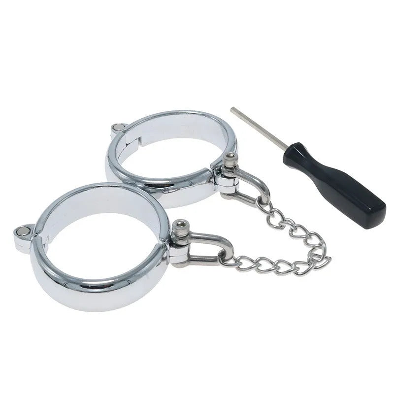 Silver zinc alloy handcuffs and footcuffs set for adults on a dark background