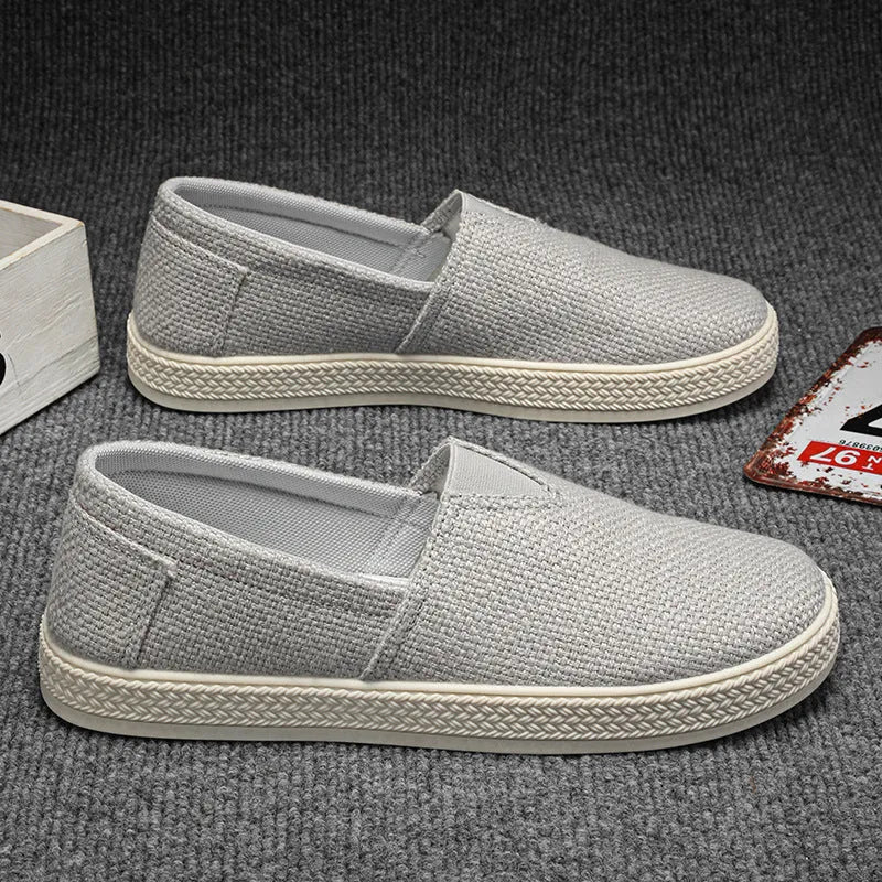Men's beige canvas casual shoes with round toe and shallow cut, shown on a white background.