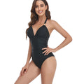 Women's backless one-piece swimsuit in a printed leopard design, showing the rear view.