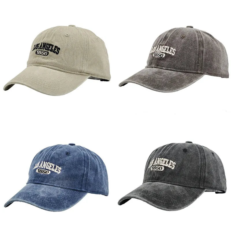Retro distressed beige cap with adjustable strap and embroidered letters on a conical crown.