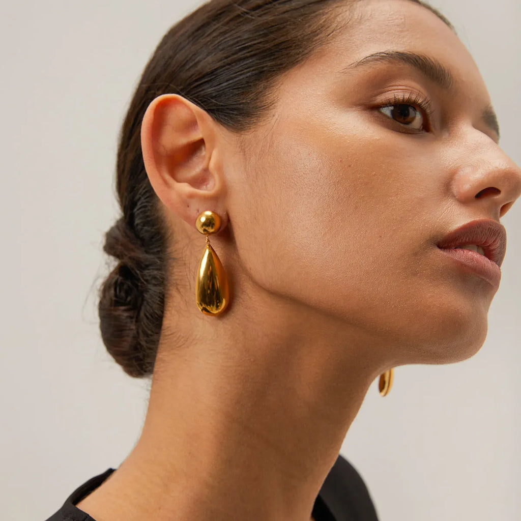 Gold geometric hemisphere water drop pendant earrings made from stainless steel.