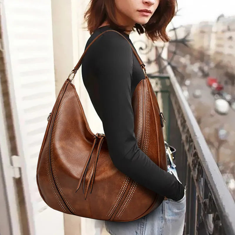Retro large capacity PU tote shoulder bag with tassel hollow detailing and zipper closure in white