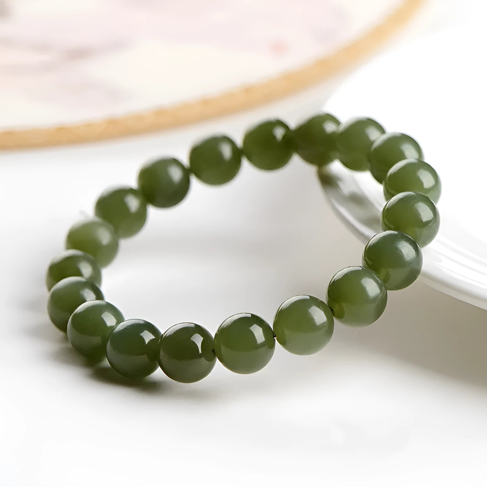 Polished Hetian jade ball bracelet in a casual unisex style with spherical beads.