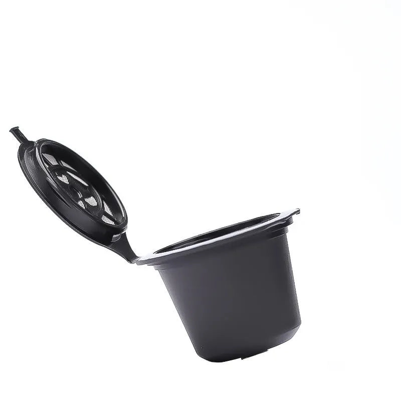 Set of six recyclable reusable plastic coffee filter cups in black, brown, and red with a spoon on wooden background
