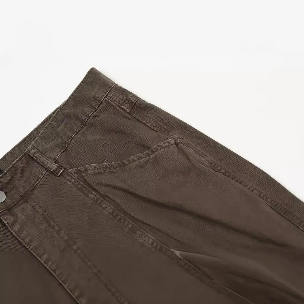 Men's brown loose-fit high-waisted straight-leg cotton trousers on a hanger.