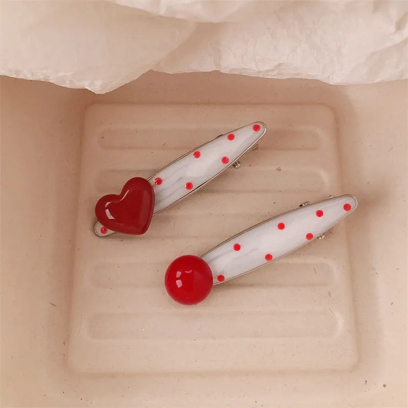 Red heart-shaped hair clip with retro dot patterns and willow leaf clip design