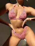 Women's floral bikini halter set with sleeveless top and shorts in polyester fabric.