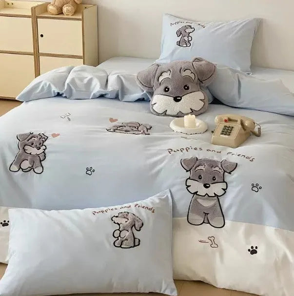 Cartoon Schnauzer design embroidered on a light blue cotton quilt cover and pillowcase.