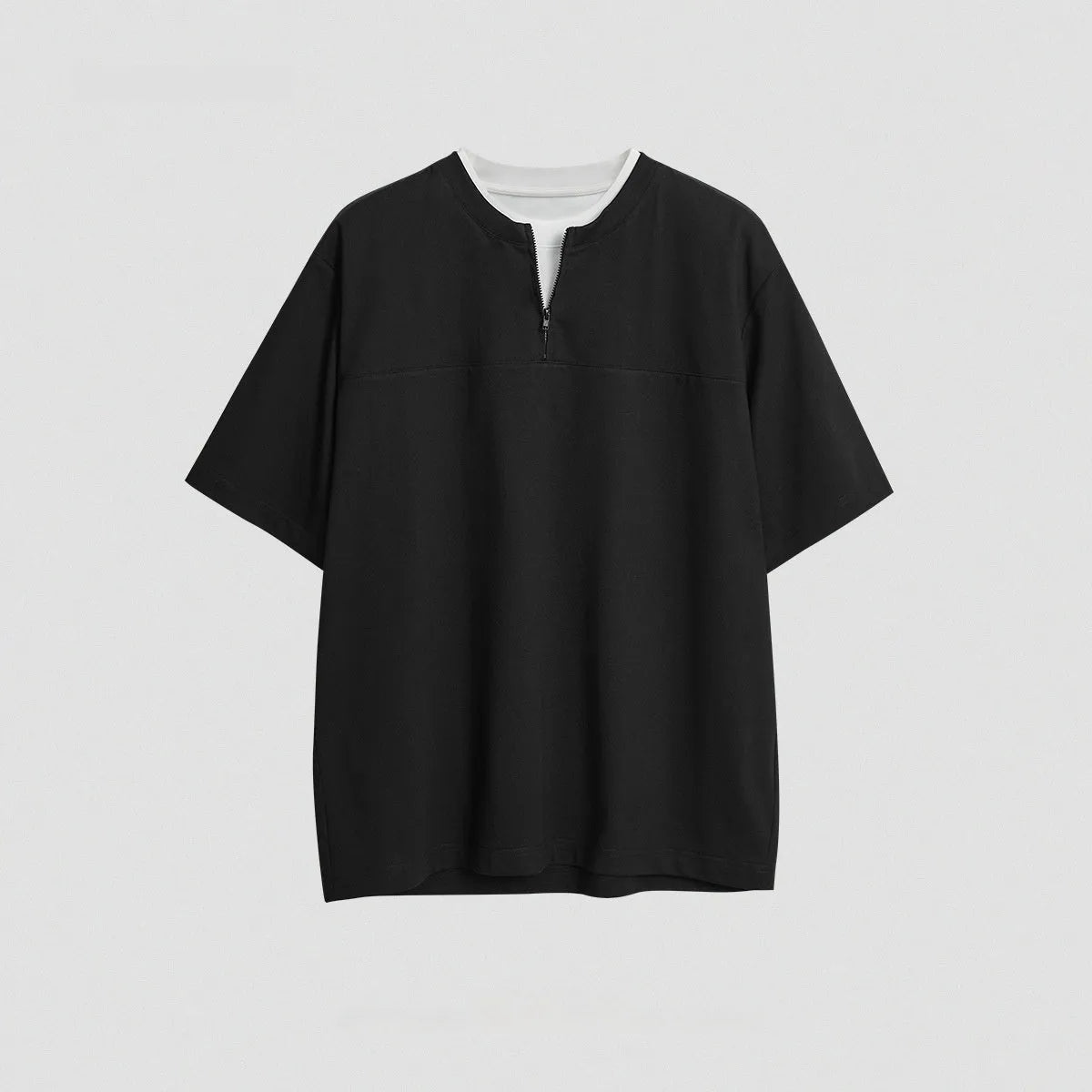 Loose blue zip-through patchwork top on a hanger, showing the false two-piece design and collar detail.