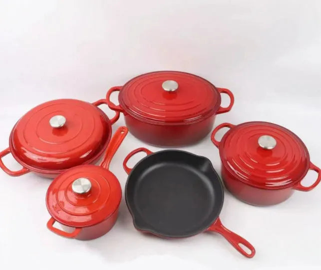 Cast iron enamel casserole set with frying pan and stew pot in light blue colour on a wooden table