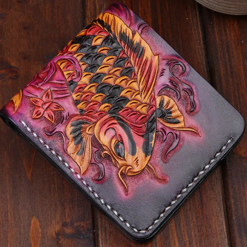 Men's hand-carved short leather wallet in blue, showing textured detail and compact size next to a card for scale.