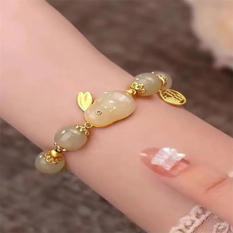 Green electroplated jade hare bracelet for women with Chinese style and lily design elements.