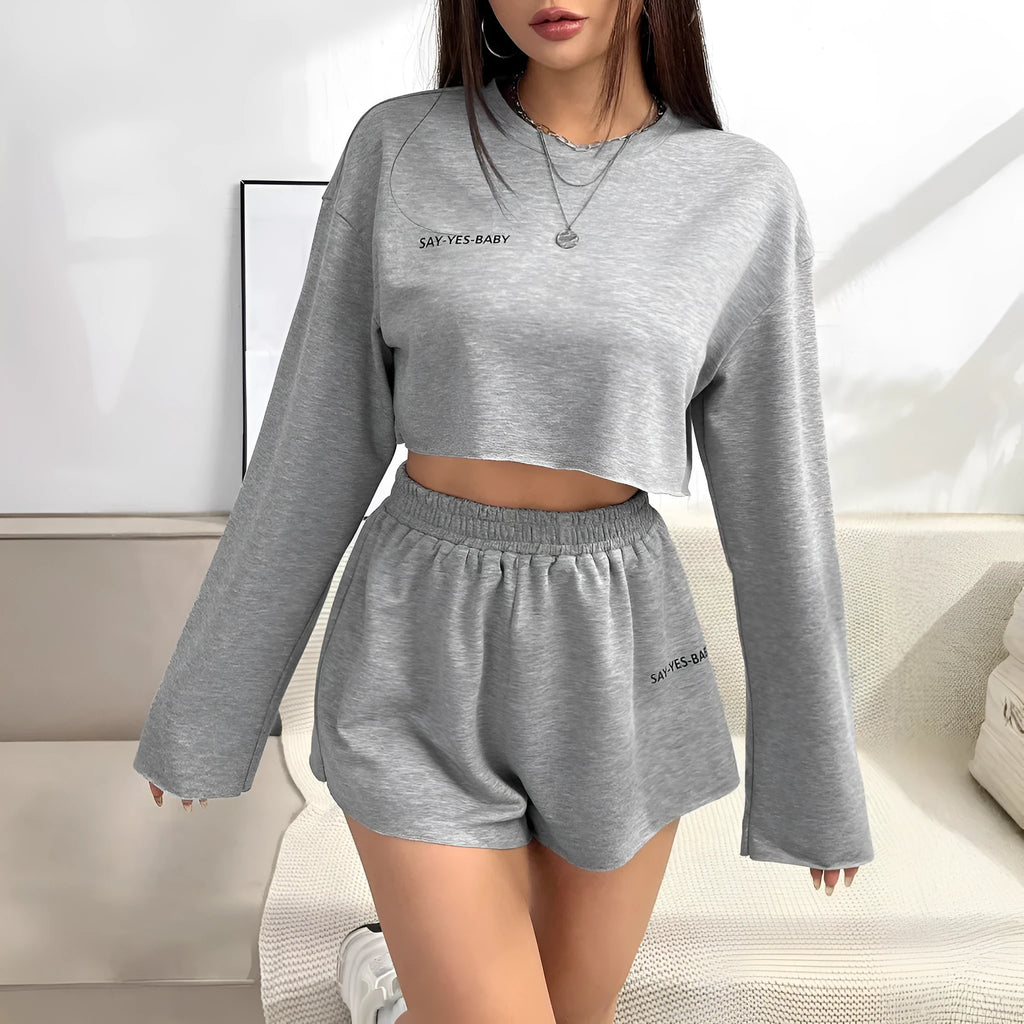 Grey women's long-sleeved t-shirt and short loungewear set laid flat showing both pieces