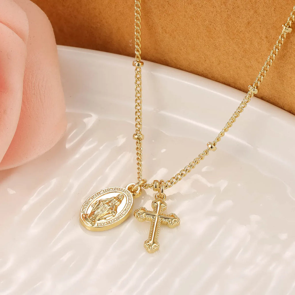 Geometric Virgin Mary cross pendant necklace in gold on a 45cm chain with lobster clasp.